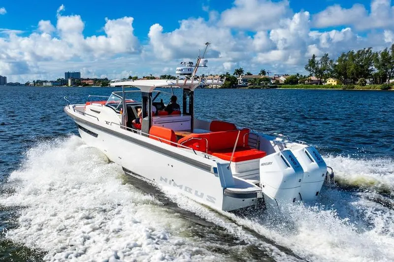 Slide: The Image of 2023 Nimbus Tender 11 cruising on a sunny day, featuring sleek design and vibrant seating. - 32