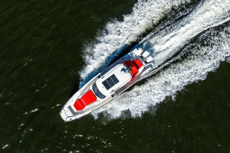 Slide: The Image of Aerial view of 2023 Nimbus Tender 11 boat speeding on water. - 34