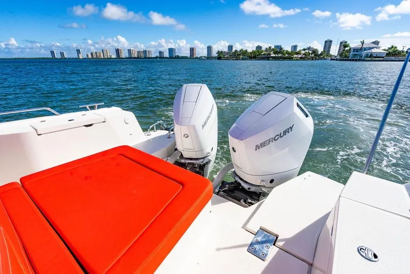 Slide: The Image of 2023 Nimbus Tender 11 with Mercury engines cruising near city skyline. - 38