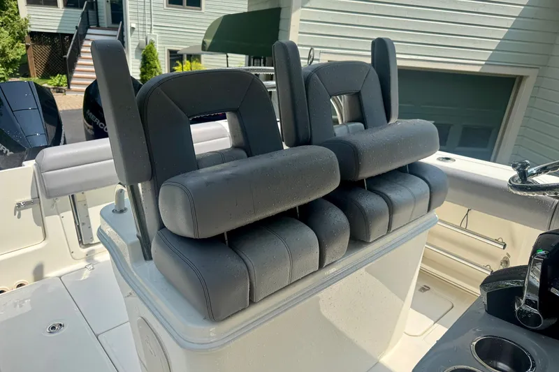 Slide: The Image of 2024 Boston Whaler 250 Outrage boat seats, featuring dual cushioned helm chairs. - 11