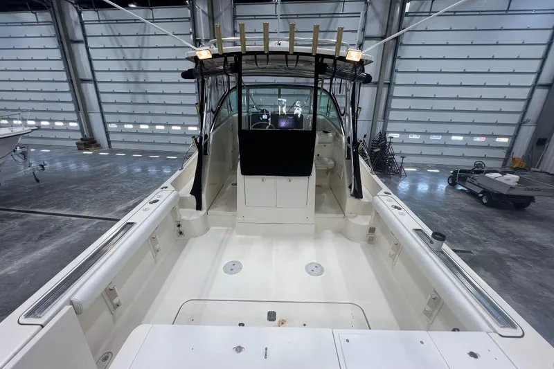 Slide: The Image of 2001 Pursuit 3070 Offshore boat in a spacious indoor storage facility. - 10