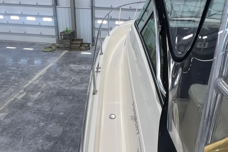 Slide: The Image of 2001 Pursuit 3070 Offshore boat in a spacious indoor storage facility. - 11