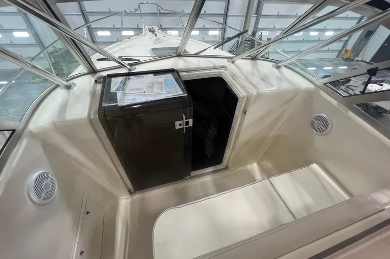 Slide: The Image of 2001 Pursuit 3070 Offshore boat interior with cabin entrance and seating area. - 17