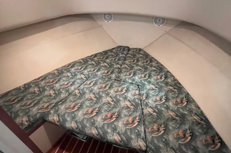 Slide: The Image of 2001 Pursuit 3070 Offshore cabin interior with patterned bedding. - 21