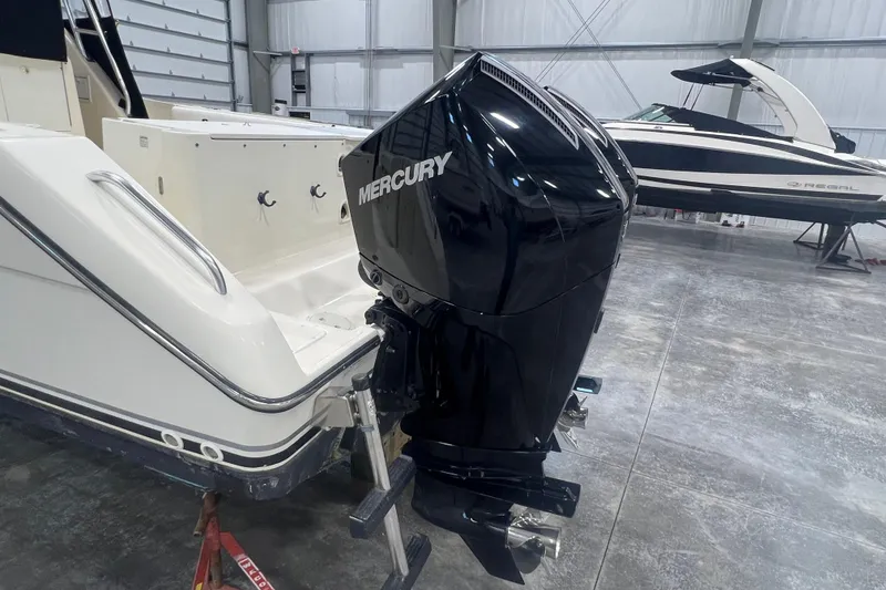 Slide: The Image of 2001 Pursuit 3070 Offshore boat with Mercury outboard motor in a storage facility. - 6