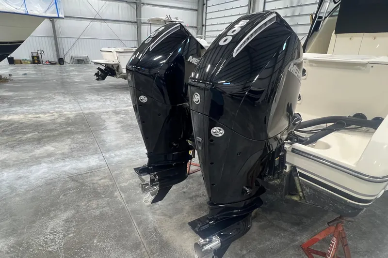 Slide: The Image of 2001 Pursuit 3070 Offshore boat with twin Mercury 300 outboard engines in a garage. - 7
