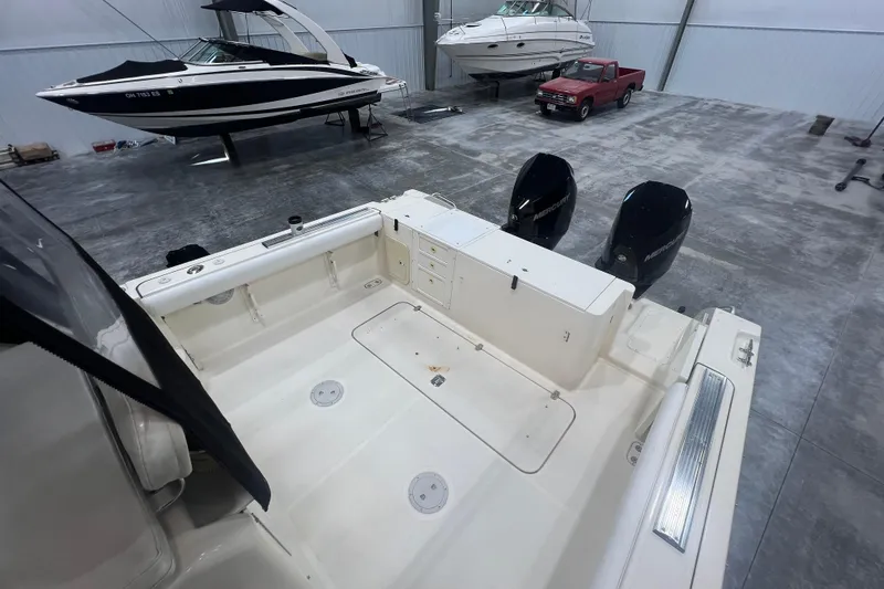 Slide: The Image of 2001 Pursuit 3070 Offshore boat in storage with dual outboard motors. - 9