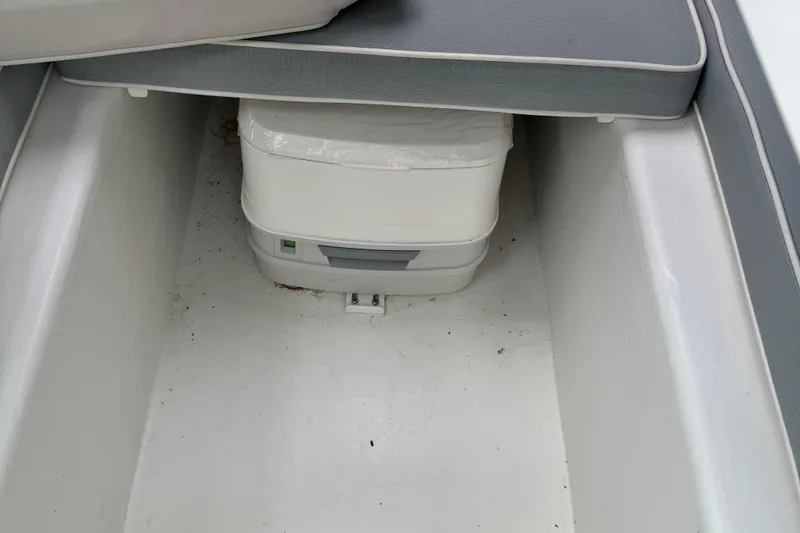 Slide: The Image of 2014 Parker 2120 Sport Cabin interior with portable toilet under seat. - 10