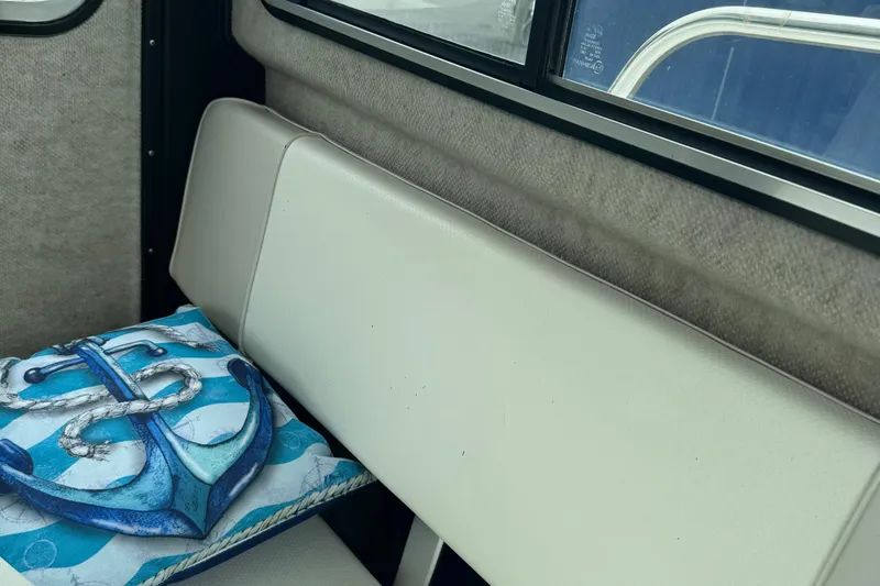 Slide: The Image of 2014 Parker 2120 Sport Cabin interior with anchor-themed cushion on white seat. - 11