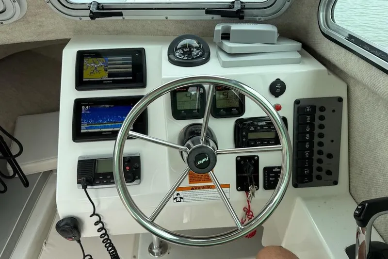 Slide: The Image of Steering console of a 2014 Parker 2120 Sport Cabin boat with navigation equipment. - 17