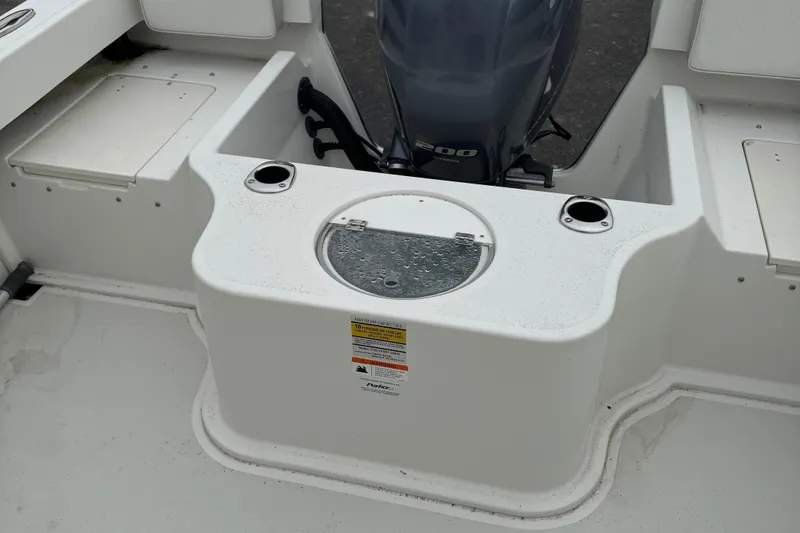 Slide: The Image of 2014 Parker 2120 Sport Cabin boat with Yamaha 200 engine, featuring a livewell and rod holders. - 6