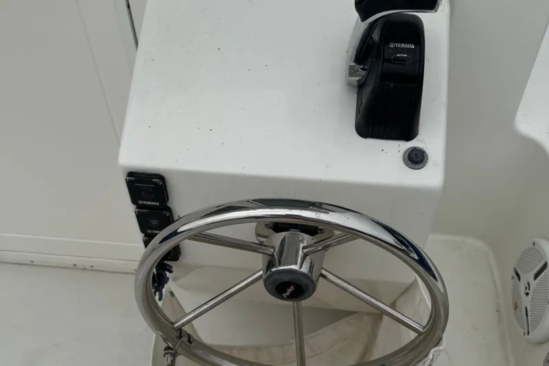 Slide: The Image of Steering wheel and controls of 2014 Parker 2120 Sport Cabin boat. - 8
