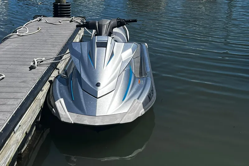 Slide: The Image of 2015 Yamaha WaveRunner VX Deluxe jet ski docked on calm water. - 2