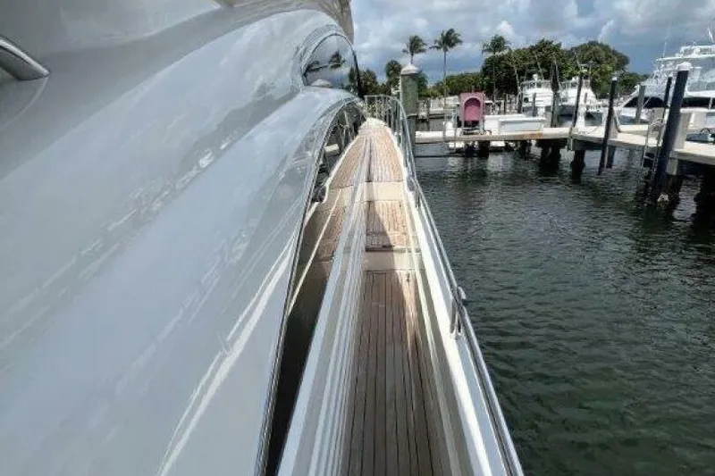 Slide: The Image of Side view of a 2006 Princess 67 Flybridge yacht docked at a marina. - 13