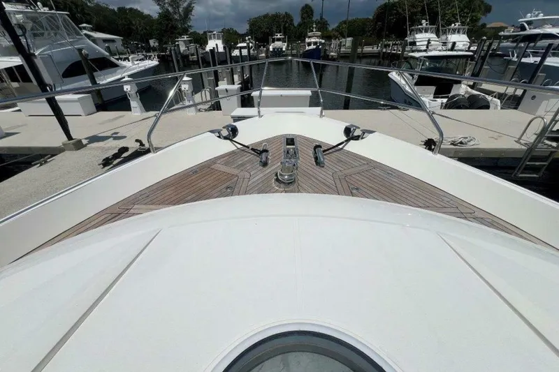 Slide: The Image of Bow view of 2006 Princess 67 Flybridge yacht docked at marina. - 14