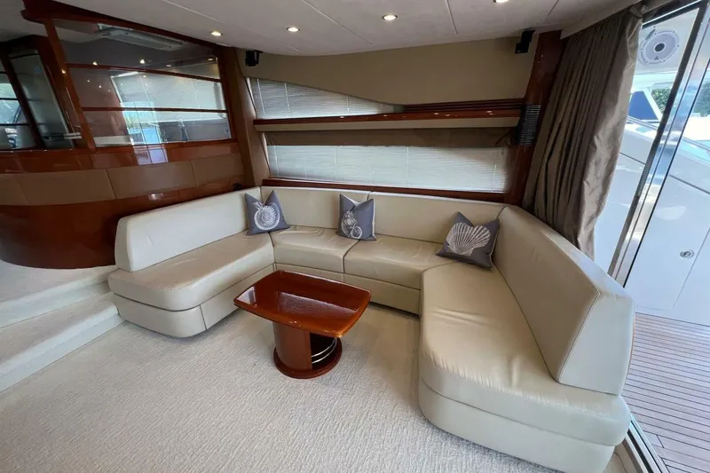 Slide: The Image of Luxurious interior of 2006 Princess 67 Flybridge yacht with elegant seating and wooden accents. - 17