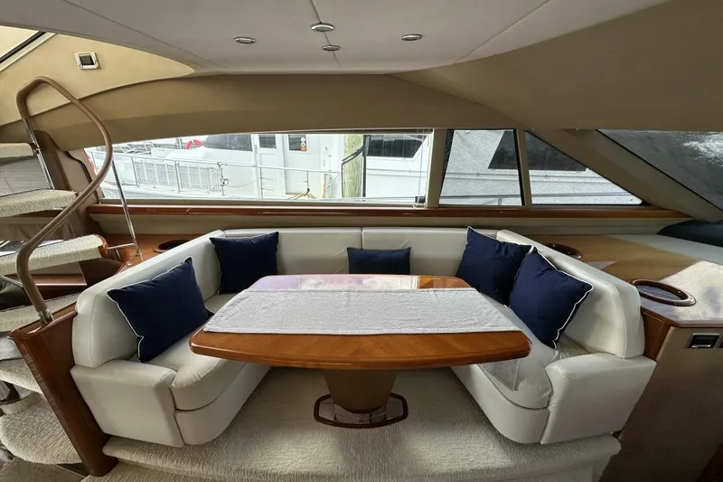 Slide: The Image of Luxurious 2006 Princess 67 Flybridge yacht interior with elegant seating and wooden table. - 19