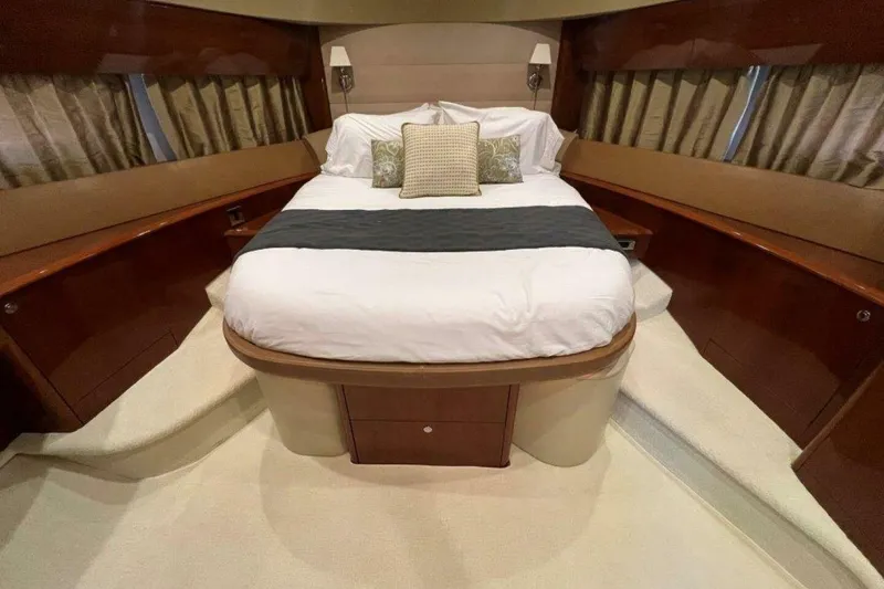 Slide: The Image of Luxurious bedroom interior of 2006 Princess 67 Flybridge yacht with elegant bedding and wood accents. - 25