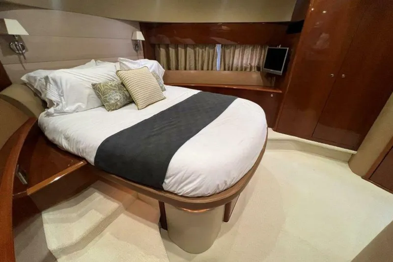 Slide: The Image of Luxurious bedroom interior of 2006 Princess 67 Flybridge yacht with elegant bedding and wood finishes. - 26