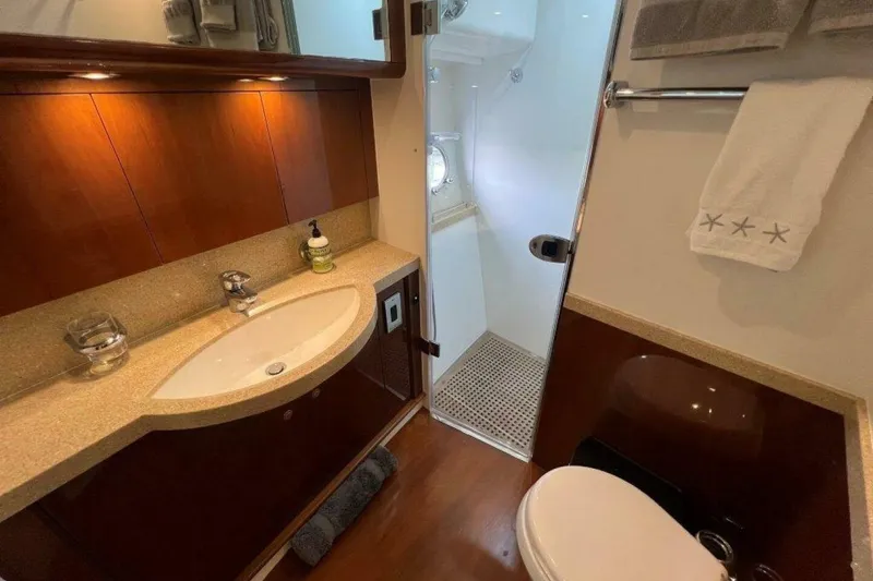 Slide: The Image of Luxurious bathroom in 2006 Princess 67 Flybridge yacht with elegant wood cabinetry and modern fixtures. - 27