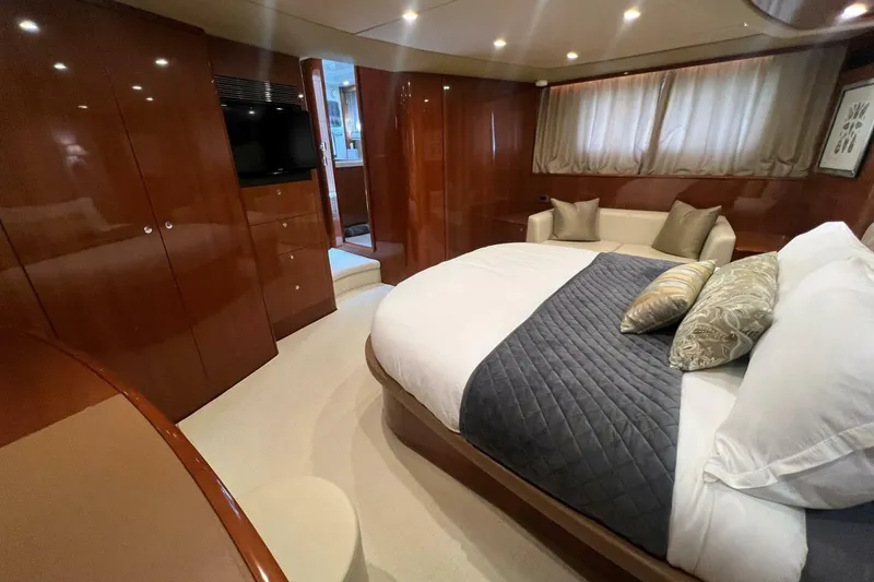 Slide: The Image of Luxurious bedroom interior of 2006 Princess 67 Flybridge yacht with elegant wood finishes. - 31