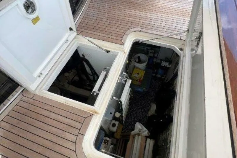 Slide: The Image of Open hatch on 2006 Princess 67 Flybridge yacht, revealing storage compartment. - 33