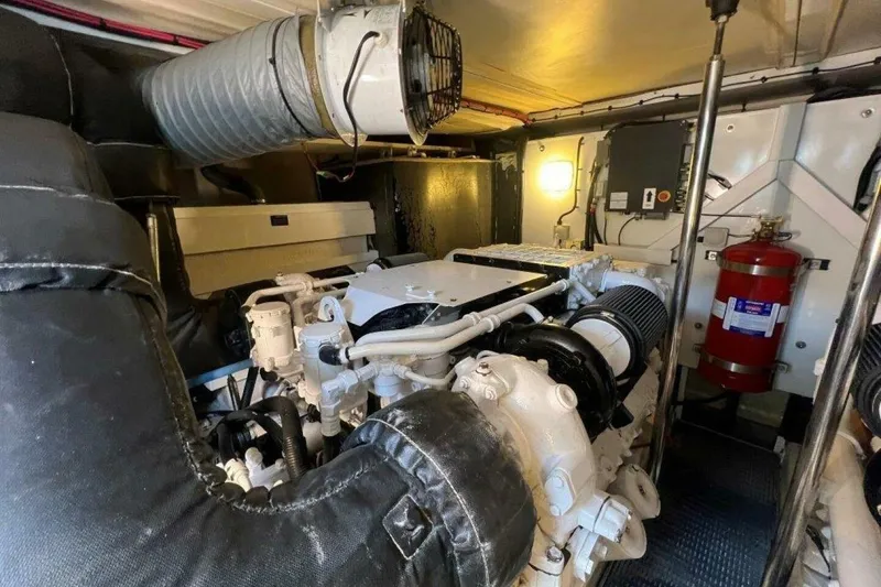 Slide: The Image of Engine room of 2006 Princess 67 Flybridge yacht, featuring machinery and fire extinguisher. - 36