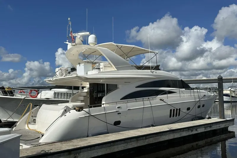 Slide: The Image of Luxury 2006 Princess 67 Flybridge yacht docked at marina under blue sky. - 37