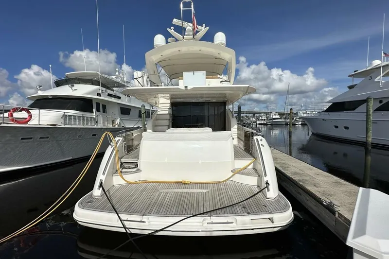Slide: The Image of 2006 Princess 67 Flybridge yacht docked at marina under clear blue sky. - 38