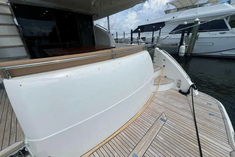 Slide: The Image of 2006 Princess 67 Flybridge yacht docked, showcasing sleek design and spacious deck area. - 4