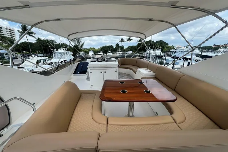 Slide: The Image of Luxurious 2006 Princess 67 Flybridge yacht with spacious seating and elegant wood table. - 7