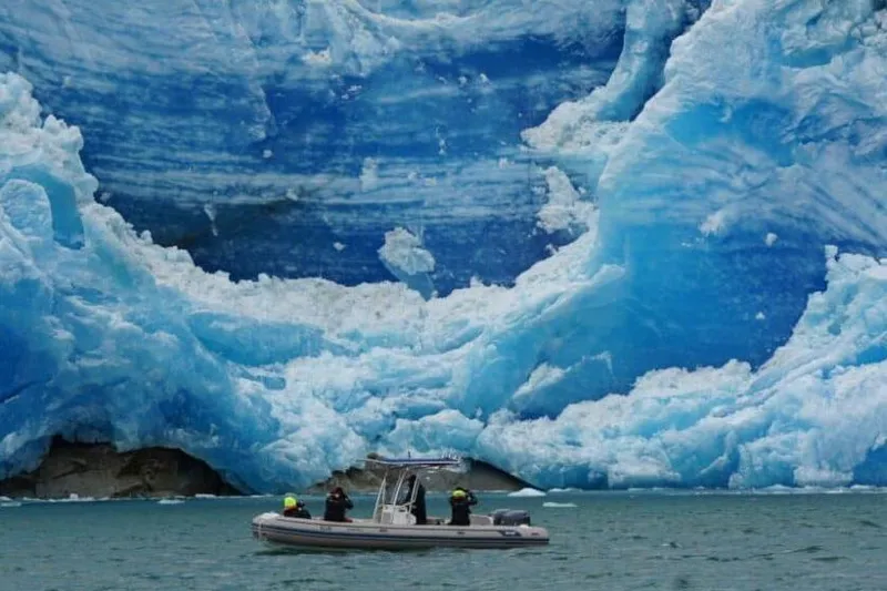 Slide: The Image of AB Inflatables Oceanus 24 VST 2026 near stunning glacier. - 6