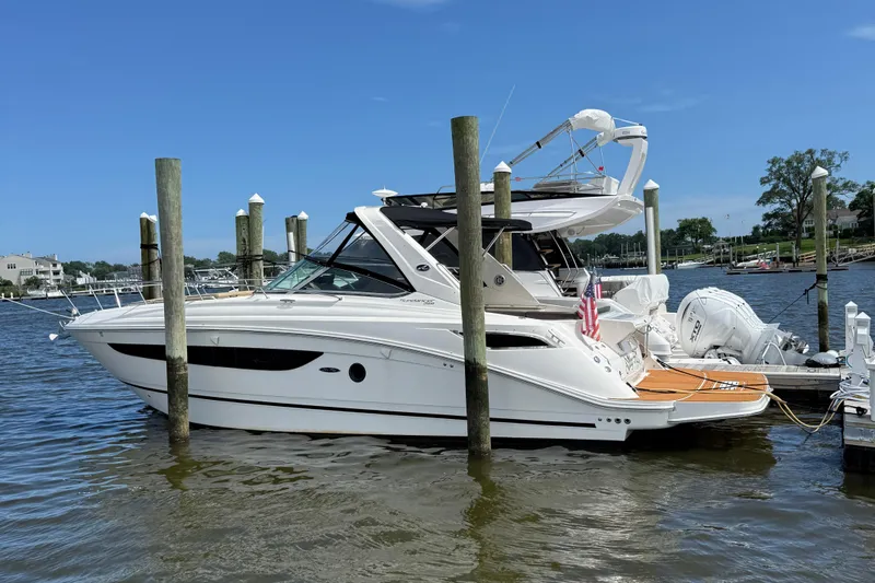 Slide: The Image of 2015 Sea Ray 350 Sundancer yacht docked at marina, clear blue sky. - 0