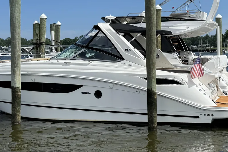 Slide: The Image of 2015 Sea Ray 350 Sundancer yacht docked with American flag. - 1