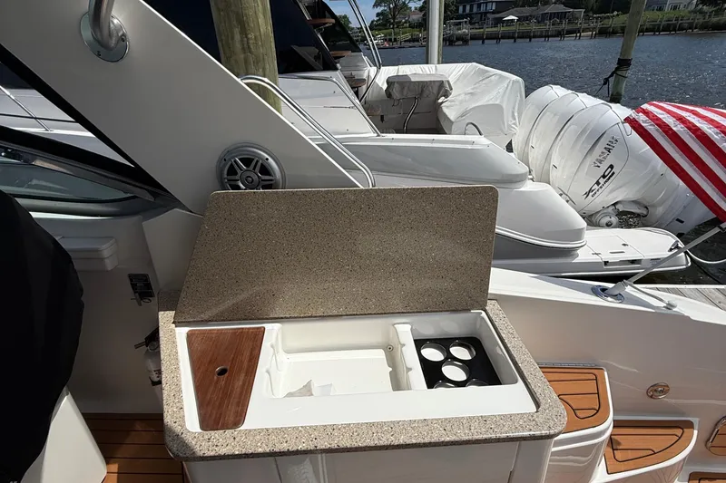 Slide: The Image of 2015 Sea Ray 350 Sundancer boat with open countertop and cup holders. - 11