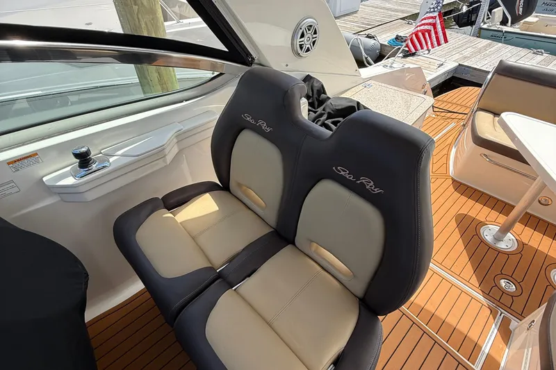 Slide: The Image of 2015 Sea Ray 350 Sundancer cockpit with dual seats and teak flooring. - 15