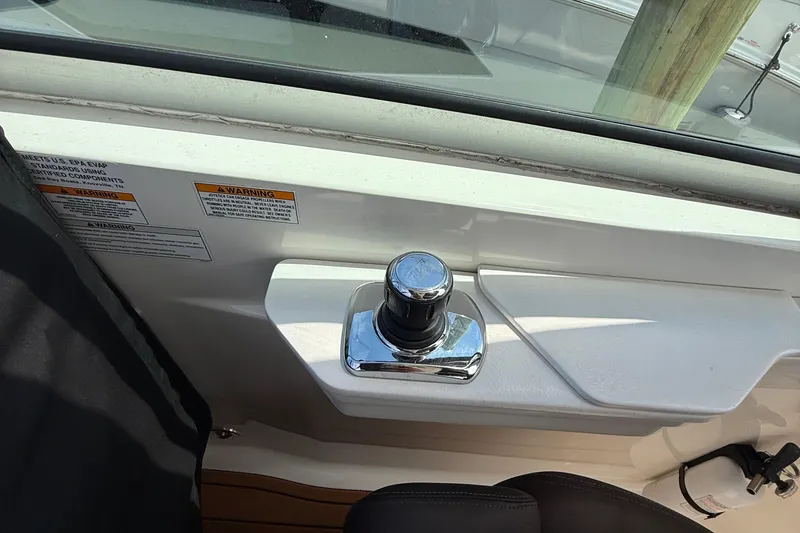 Slide: The Image of 2015 Sea Ray 350 Sundancer boat control panel with joystick and warning labels. - 16