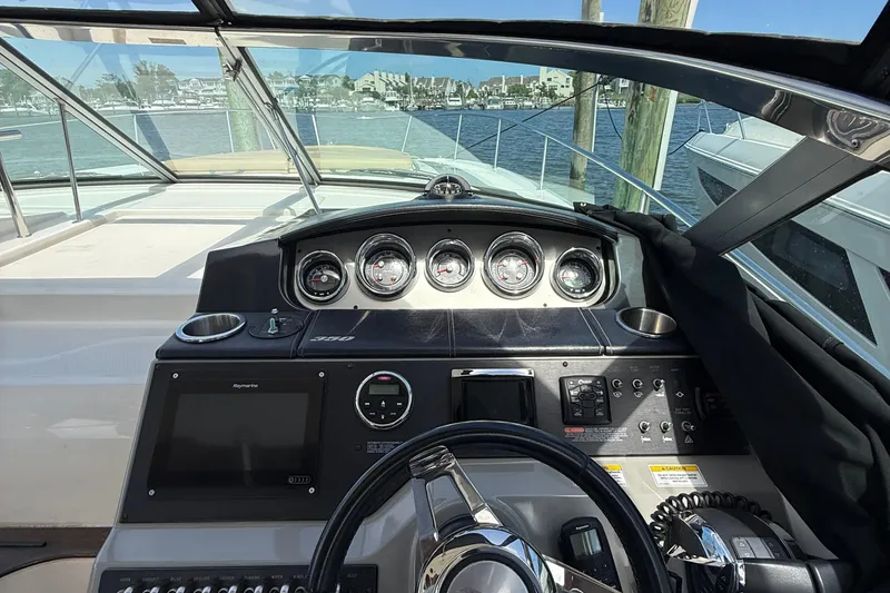 Slide: The Image of Cockpit view of 2015 Sea Ray 350 Sundancer with gauges and navigation equipment. - 17