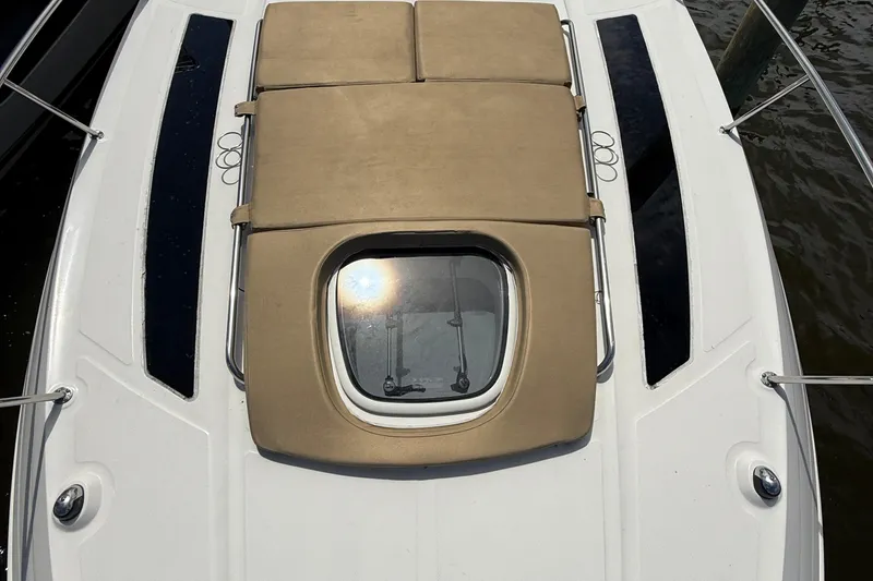 Slide: The Image of 2015 Sea Ray 350 Sundancer boat deck with sunroof and cushioned seating. - 20