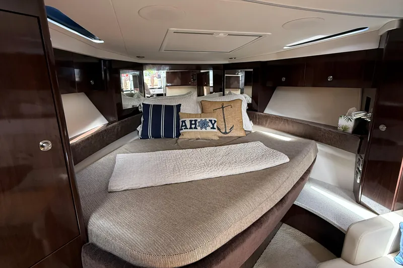 Slide: The Image of Luxurious interior of 2015 Sea Ray 350 Sundancer yacht with cozy bedding and nautical decor. - 23