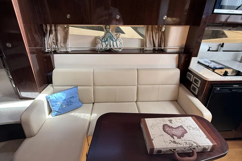Slide: The Image of Luxurious interior of 2015 Sea Ray 350 Sundancer with cream sofa and nautical decor. - 24