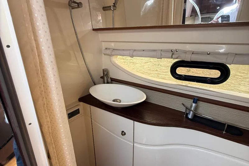 Slide: The Image of 2015 Sea Ray 350 Sundancer bathroom with modern sink and shower. - 26