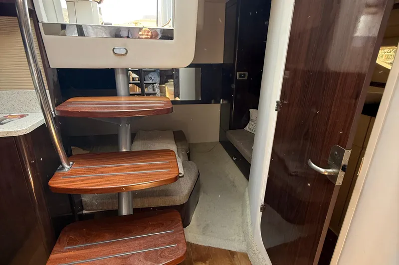 Slide: The Image of Interior of 2015 Sea Ray 350 Sundancer with wooden steps and modern design. - 31