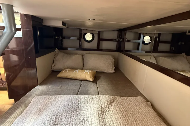Slide: The Image of Cozy cabin interior of 2015 Sea Ray 350 Sundancer with bed and pillows. - 33