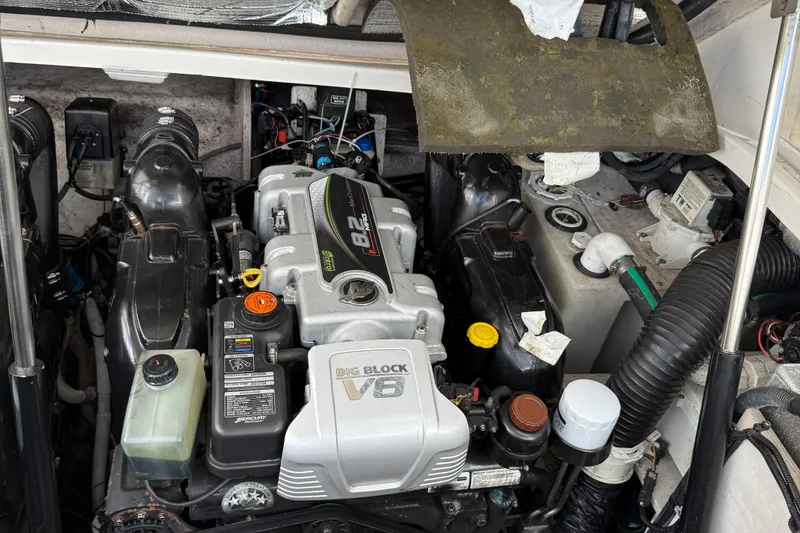 Slide: The Image of Engine compartment of a 2015 Sea Ray 350 Sundancer boat, featuring a powerful V8 engine. - 37