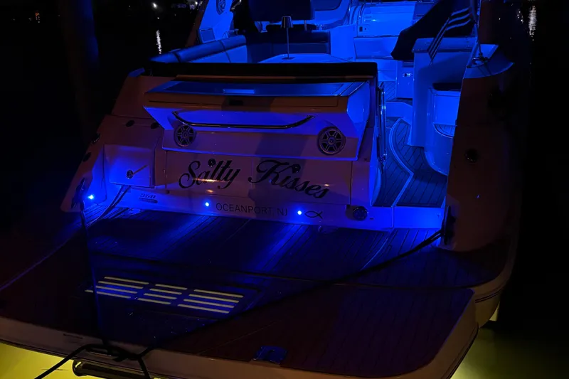 Slide: The Image of 2015 Sea Ray 350 Sundancer yacht with blue LED lights at night. - 39