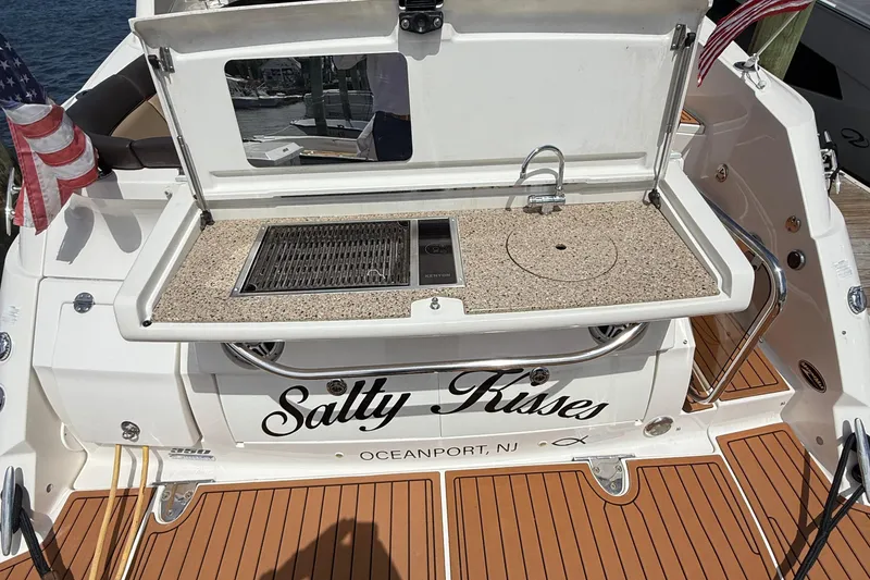 Slide: The Image of 2015 Sea Ray 350 Sundancer boat with outdoor kitchen and "Salty Kisses" name. - 5