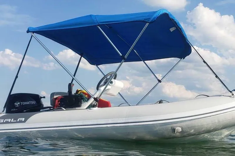 Slide: The Image of Gala A330hq 2026 inflatable boat with blue canopy on water. - 5