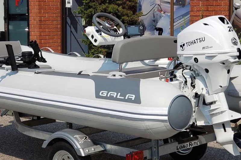 Slide: The Image of Gala A330hq 2026 inflatable boat with Tohatsu engine on trailer. - 7