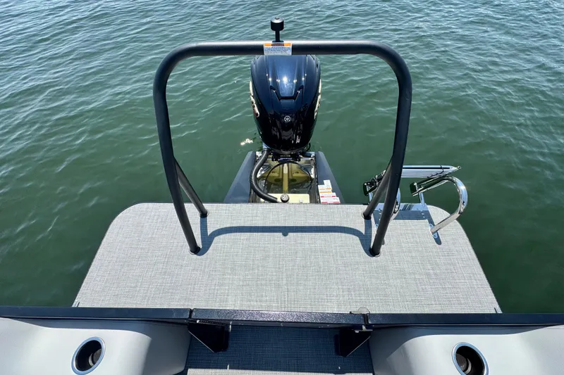 Slide: The Image of 2026 Veranda Vista Sport VS25RC boat with motor on calm water. - 10